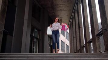 Stylish girl with shopping bags, rejoicing discounts in store, dancing, celebrating. Black Friday video