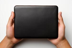 A man holds a black cover with a place for writing in his hands. photo