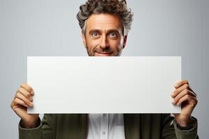 Portrait of a man holding a white horizontal sheet of paper with a place for writing and mockup. photo