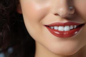 A snow-white smile of a girl with bright red lipstick on her lips. photo