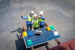 Portrait of Engineer or foreman team pointing up the future  with cargo container background at sunset. Logistics global import or export shipping industrial concept. photo