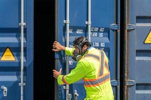 Engineer wear PPE urgently assisted the male technique inside container as Chemical spill in the container shipping industry photo