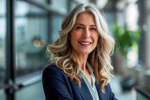 Portrait of middle aged happy business woman in office, closeup photo