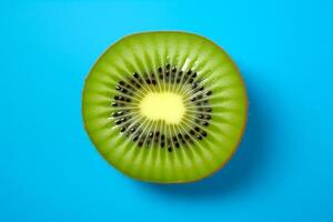 Kiwi slice isolated on a blue background, top view photo