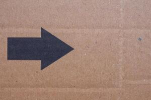 Arrow sign on cardboard paper, copy space photo