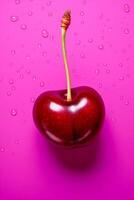 Single cherry isolated on pink background, top view photo