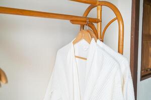 white bathrobe hanging in bathroom photo