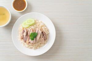 Hainanese Chicken Rice or steamed rice with chicken photo