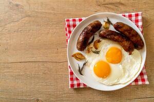 double fried egg with pork sausage photo