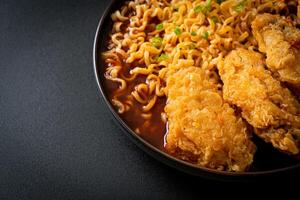 Korean instant noodles with fried chicken or Fried chicken ramyeon photo