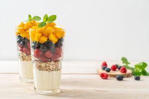 homemade mango, raspberry and blueberry with yogurt and granola photo
