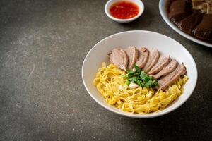 dried duck noodles in white bowl photo