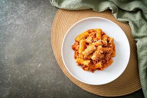 Rigatoni pasta bolognese with cheese photo