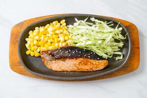 grilled salmon fillet steak on hot plate photo
