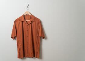 shirt with wood hanger on wall photo