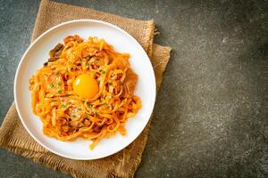 stir-fried udon noodles with kimchi and pork photo