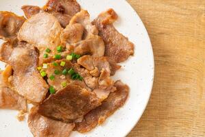 grilled pork neck sliced on plate photo