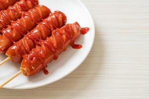 fried sausage skewer with ketchup photo