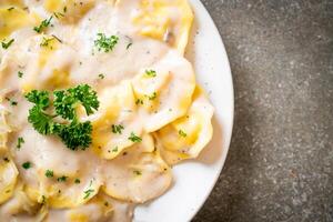 ravioli pasta with mushroom cream sauce and cheese photo