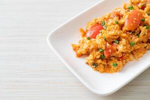 Stir-fried tomatoes with egg or Scrambled eggs with tomatoes photo