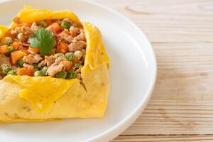 egg wrap or stuffed egg with minced pork and vegetable photo