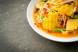 Som Tum - Thai spicy papaya salad with corn photo