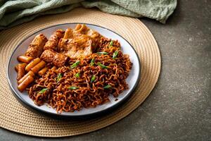 Jajangmyeon or JJajangmyeon with Odeng and Omuk - Korean Instant noodles with Korean fish cake in black bean sauce photo