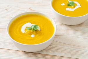 pumpkin soup in white bowl photo