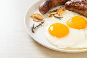 double fried egg with pork sausage photo