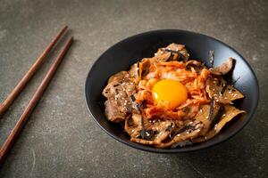 pork bulgogi rice bowl with kimchi and Korean pickled egg photo