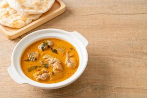 Chicken curry soup with roti photo