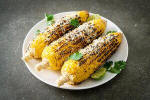 barbecue and grilled corn with cheese and lime photo