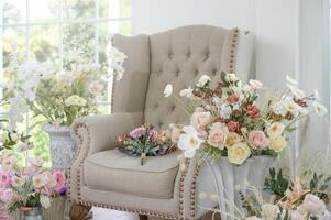 Interior of armchair decorated with Beautiful flowers for wedding ceremony. photo