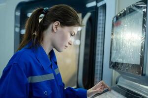 Female Robotics engineers Using Controller to Remotely Operate programming and Manipulating Robot Hand, Industrial Robotics Design, High Tech Facility, Modern Machine Learning. photo