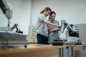 aprendiz robótica ingeniero aprendizaje con programación y manipulando robot mano, industrial robótica diseño, alto tecnología instalación, moderno máquina aprendiendo. masa producción automáticas. foto