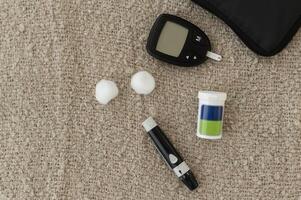 Background of Digital Glucose meter kit for checking blood sugar level, health care, medicine, diabetes, glycemia concept photo