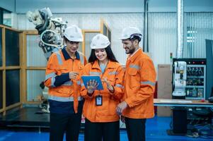 A group of Robotics engineers working with Programming and Manipulating Robot Hand, Industrial Robotics Design, High Tech Facility, Modern Machine Learning. Mass Production Automatics. photo
