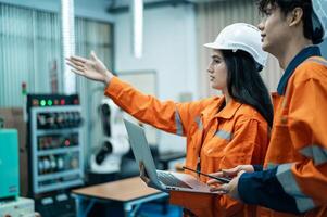 A group of Robotics engineers working with Programming and Manipulating Robot Hand, Industrial Robotics Design, High Tech Facility, Modern Machine Learning. Mass Production Automatics. photo