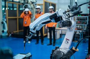 un grupo de robótica ingenieros trabajando con programación y manipulando robot mano, industrial robótica diseño, alto tecnología instalación, moderno máquina aprendiendo. masa producción automáticas. foto