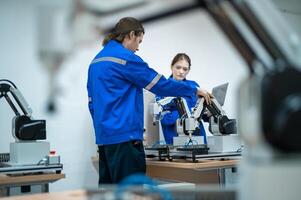 A group of Robotics engineers working with Programming and Manipulating Robot Hand, Industrial Robotics Design, High Tech Facility, Modern Machine Learning. Mass Production Automatics. photo