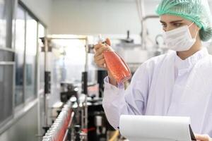 quality inspector food or beverages technician inspection about quality control food or beverages before send product to the customer. Production leader recheck ingredient and productivity. photo