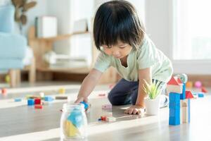 Happy Asia children play and learn toy blocks.family is happy and excited in the house. daughter having fun spending time, Activity, development, IQ, EQ, meditation, brain, muscles, essential skills. photo