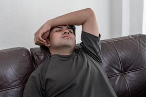 Depression and mental illness. Asian man disappoint, sad after receive bad news. Stressed boy confused with unhappy problem, arguing with girlfriend, cry and worry about unexpected work, down economy. photo