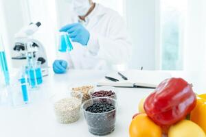 Scientist check chemical food residues in laboratory. Control experts inspect quality of fruits, vegetables. lab, hazards, ROHs, find prohibited substances, contaminate, Microscope, Microbiologist photo