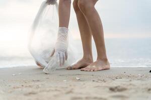 Save water. Volunteer pick up trash garbage at the beach and plastic bottles are difficult decompose prevent harm aquatic life. Earth, Environment, Greening planet, reduce global warming, Save world photo