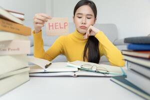 Asian student woman have anxiety because of exams, female prepare for test and learning lessons in the library. stress, despair, haste, misunderstanding reading, discouraged, expectation, knowledge photo