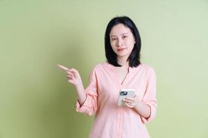 Photo of young Asian woman on background