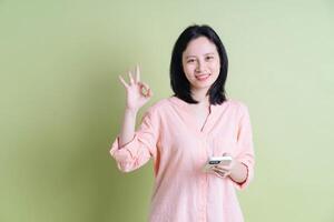 Photo of young Asian woman on background