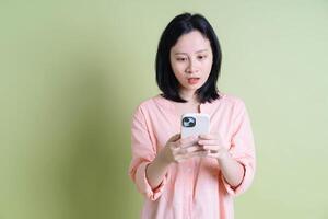 Photo of young Asian woman on background