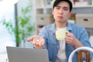 Young Asian businessman working at home photo